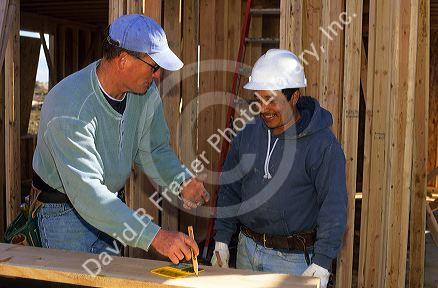 Construction worker listening to foreman supervisor for direction.