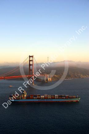 A container ship passes under the Golden Gate Bridge in the San Francisco Bay, California.
