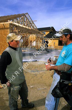 A job interview being held on a new home construction site in Idaho.