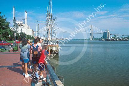 Riverfront and port in Savannah, Georgia with suspension bridge across the Savannah River.