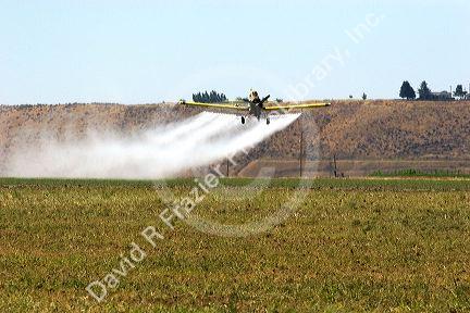 Cropduster applying chemical spray on field in Eastern Oregon.