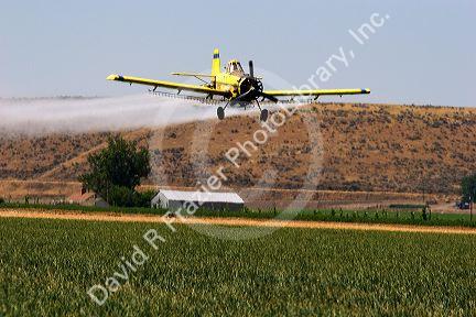Cropduster applying chemical spray on field in Eastern Oregon.