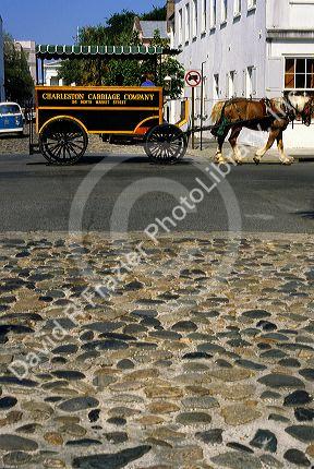 A horse and carriage tour on a cobblestone street at the East Bay of Charleston, South Carolina.