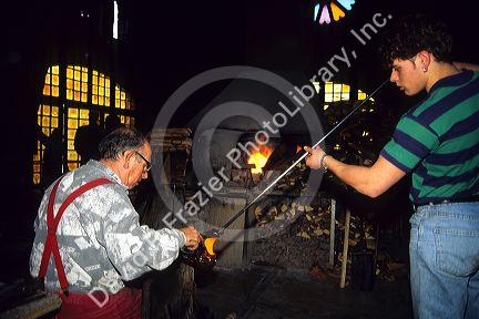 Glass blowing in Algaida, Majorca, Spain. Master glassblower and apprentice.