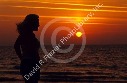 A woman silhouetted at sunset on the Florida Gulf Coast. MR