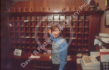 Desk clerk at Spanish hotel gets keys to a room.