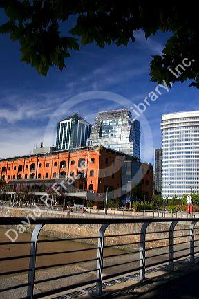 Modern office buildings and older red brick building at Puerto Modero in Buenos Aires, Argentina.