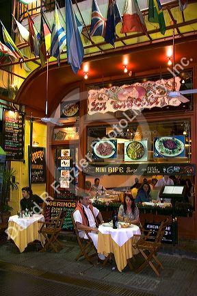 Customers sit at tables outside a restaurant in Buenos Aires, Argentina.