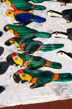Vendor inventory of animals and birds carved out of wood on display at Iguazu Falls, Argentina.