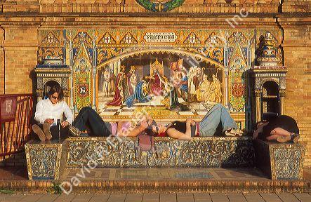 Students lounge at Pamplona mosaic in Plaza de Espana in Seville.