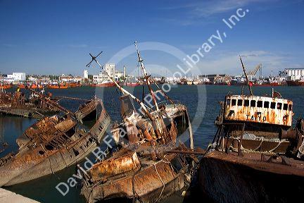 Junk fishing boats rust in the water at Puerto Faro, Mar del Plata, Argentina.