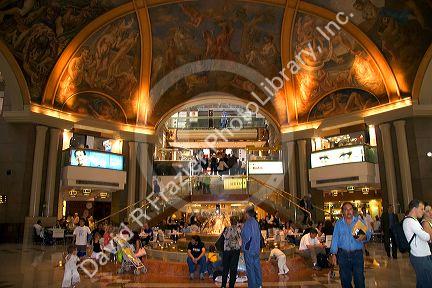 Fresco paintings adorn the ceiling of Galeria Pacifico and cafe seating in Buenos Aires, Argentina.