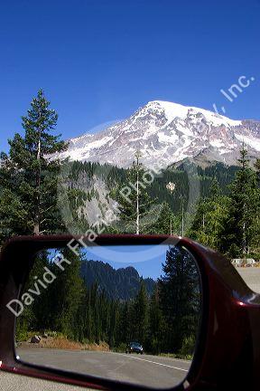 Mt. Rainier in Mt. Rainier National Park, Washington with Cascade Range reflected in auto mirror.