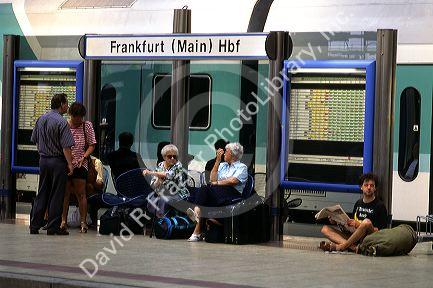 Passengers waiting at the train station in Frankfurt, Germany.