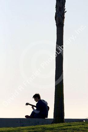 Musician playing the guitar at Venice Beach in Los Angeles, California.