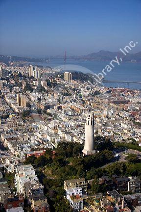 Aerial view of the city and bay of San Francisco, California with Coit Tower and Golden Gate Bridge in the background.