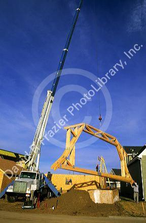 Truck mounted crane delivering trusses in Boise, Idaho.