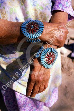 Indian pueblo woman wearing turquoise jewelry on her wrists in Taos, New Mexico.