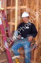 Portrait of carpenter on the job in Boise, Idaho. With pneumatic nailer air gun.