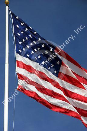 American flag raised on a flag pole.