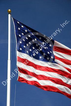 American flag raised on a flag pole.