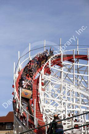 People ride a rollercoaster at the Santa Cruz Beach Boardwalk, California.