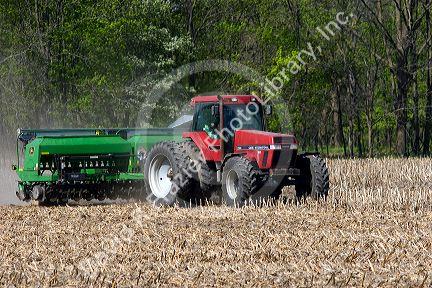 Tractor using the practice of minimum tillage for planting soy beans over last years corn crop near Clarksville, Michigan.