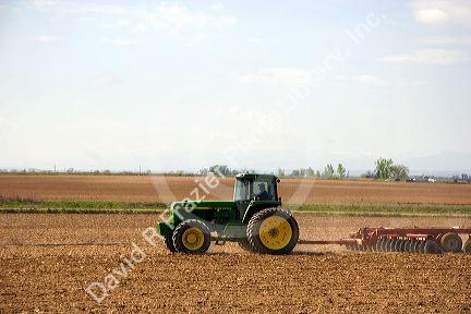 A tractor spring tilling a crop in Canyon County, Idaho.
