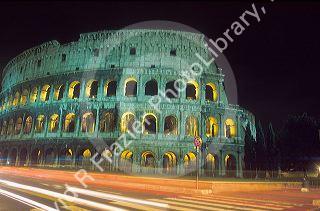 The Colosseum in Rome, Italy with light streaks from passing cars during time exposure.