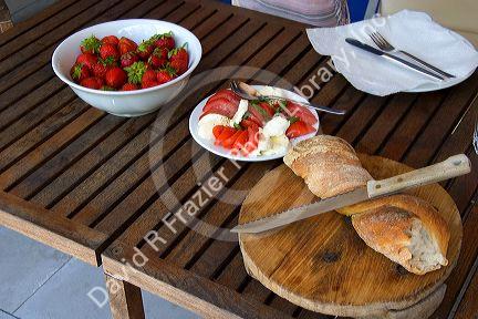 Light lunch of strawberries, tomato, cheese, and bread in Switzerland.
