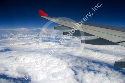 An airliner wing above the clouds.