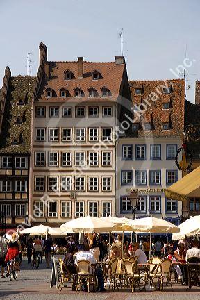 People gather in Cathedral Plaza and outdoor cafe at Strasbourg, France.