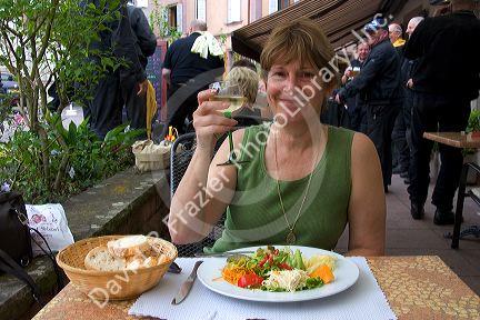 A woman having lunch at a restaurant in the village of Ribeauville, Eastern France.