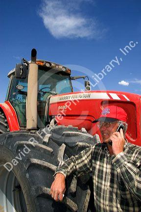 Farmer using a cell phone in the field.