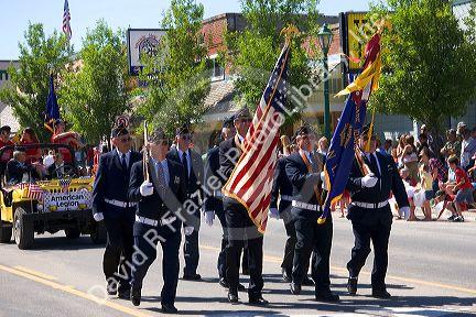 American Legion military veterans honor guard march in a small town Fourth of July parade in Cascade, Idaho.