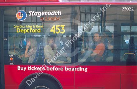London transport bus.  Passengers looking out window.