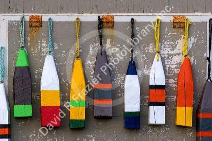 Lobster buoys hang on a wall at a village north of North Rustico on Prince Edward Island, Canada.