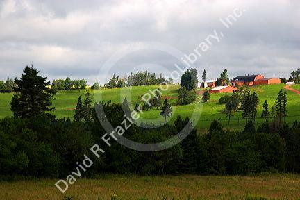 Farm and red barn on a hill at New Glasgow, Prince Edward Island, Canada.