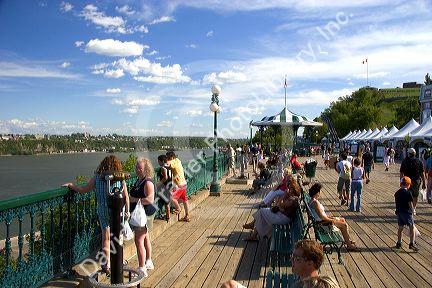 People hang out on the boardwalk in front of the Chateau Frontenac at Quebec City, Quebec, Canada.