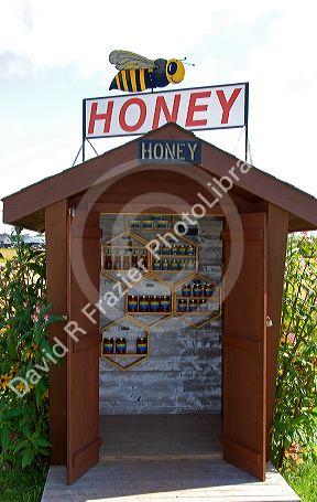 A self serve honey stand on a farm at Prince Edward Island, Canada.