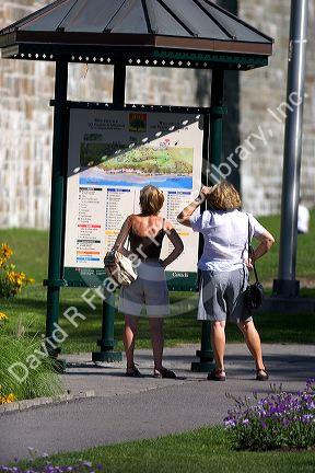 Women tourists look at a map of Quebec City, Quebec, Canada.