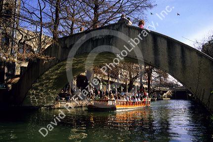 Visitors on a boat tour along the River Walk in San Antonio, Texas.