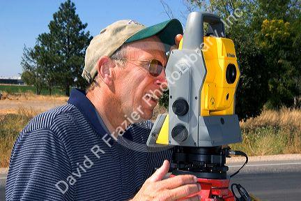 Surveyor using a laser transit in Boise, Idaho.