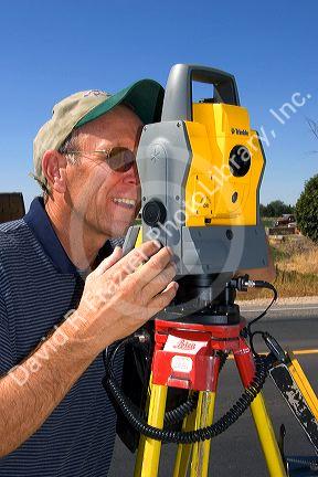 Surveyor using a laser transit in Boise, Idaho.