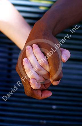 Interracial couple holding hands. MR