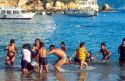 Hispanic family swimming at the beach in Acapulco, Mexico.