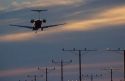 Airplane landing at sunset dusk in Los Angelas, California at LAX airport.