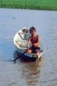 Native boy paddling his canoe on an arm of the Amazon River near Manaus Brazil.