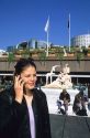 French woman using a cell phone in Paris, France.