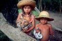 Young brazillian boy and girl holding python snakes in the jungle near Manaus Brazil.